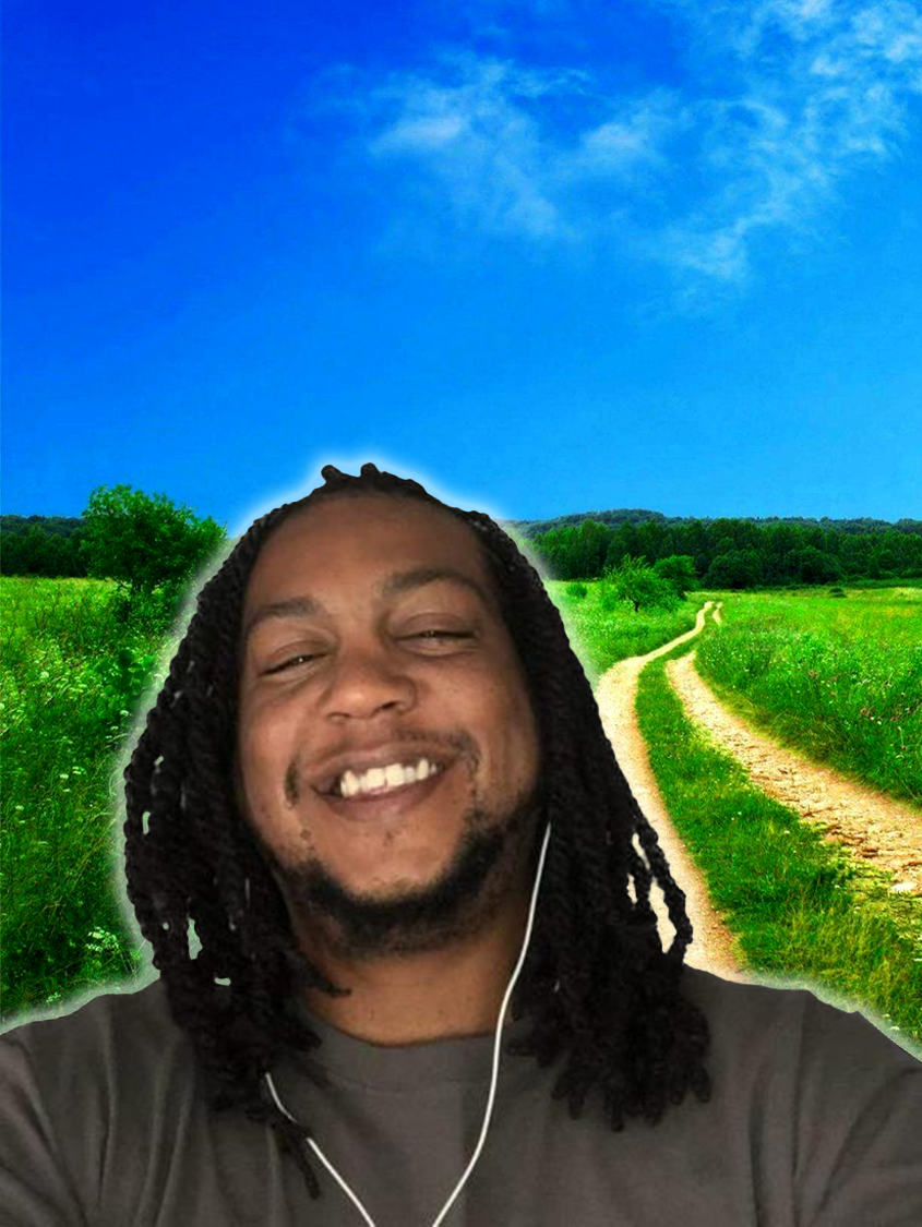 Kenny laughing joyfully in a green meadow